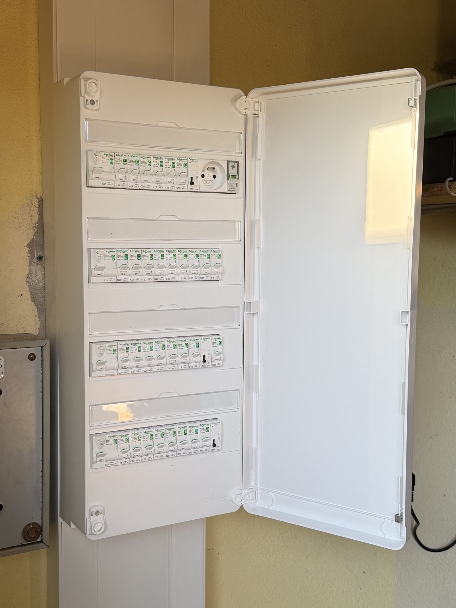 Tableau électrique propre et rangé installé par Solazura, quatre rangées de disjoncteurs Schneider Electric